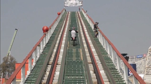 The daredevil wheelies his way up the ramp to reach one of the highest points on the rollercoaster in Mexico